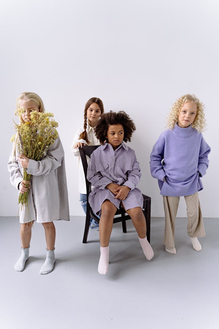 creative-03 A group of children wearing stylish clothes poses in a modern studio setup.